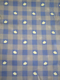 Checkered fabric with purple and light purple squares and white spots.